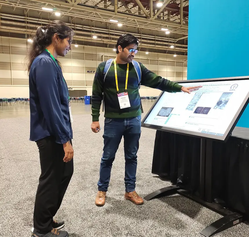 Explaining results at an AGU e-poster kiosk.