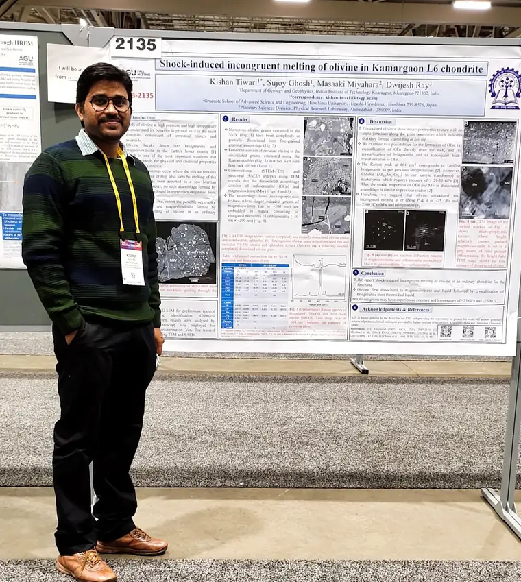 Standing beside the printed conference poster.